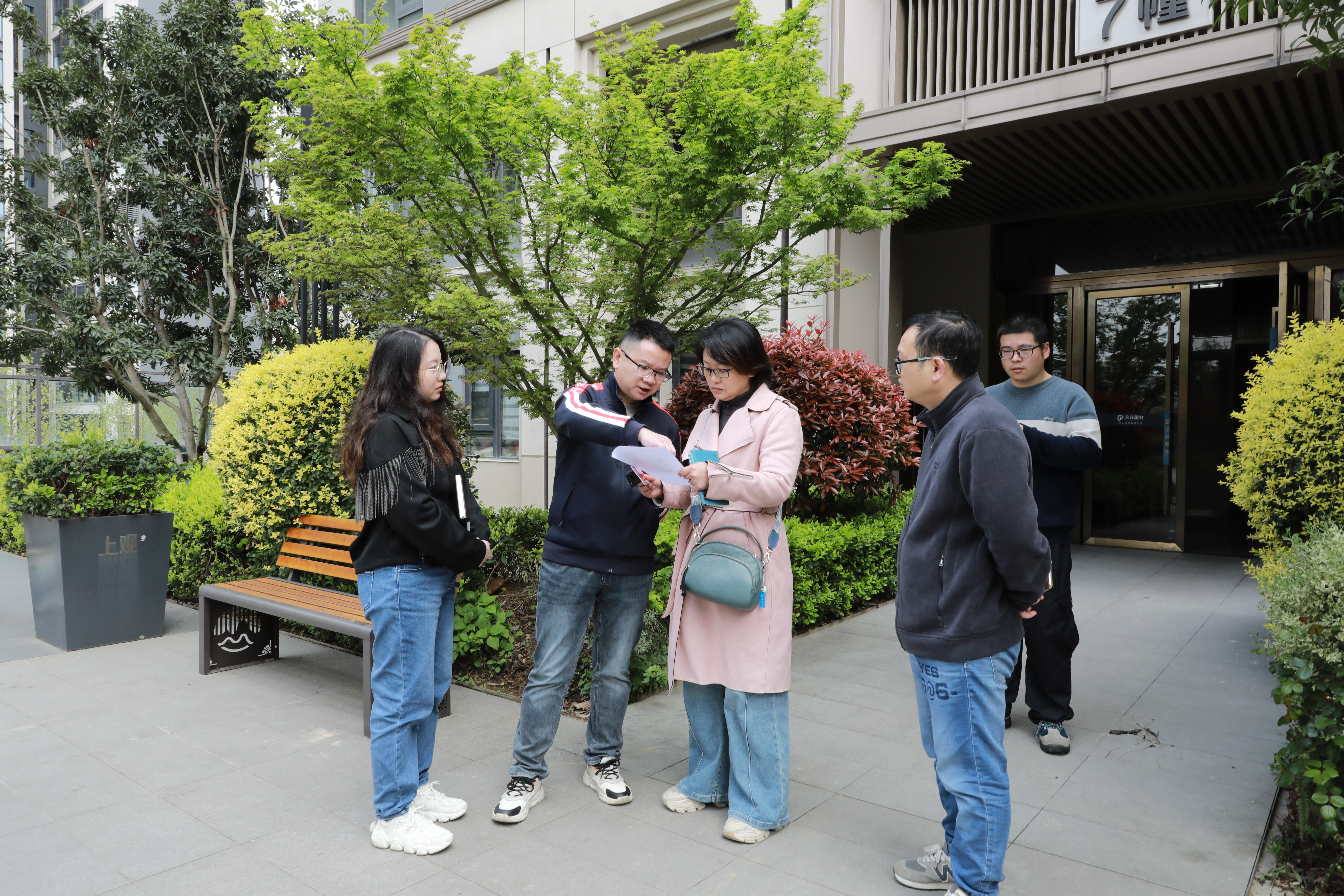 清镇市住建局副局长(左二)向问政记者介绍房屋漏水具体情况